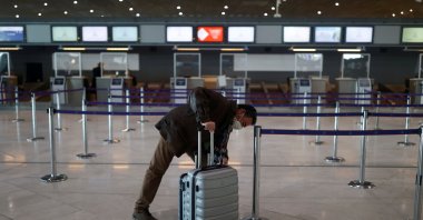 A passenger waits for check-in in the departures area of Terminal 2E at Charles-de-Gaulle airport amid the coronavirus outbreak, in Roissy, near Paris, France, April 2, 2021. (Reuters Photo)