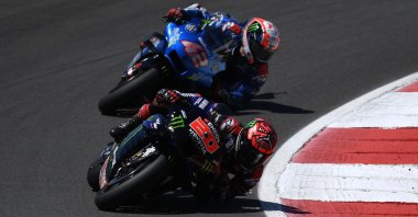 Monster Energy Yamaha MotoGP's French rider Fabio Quartararo and Team Suzuki Ecstar's Spanish rider Alex Rins (back) compete in the MotoGP Portuguese Grand Prix at the Algarve International Circuit, Portimao, Portugal, April 18, 2021. (AFP Photo)