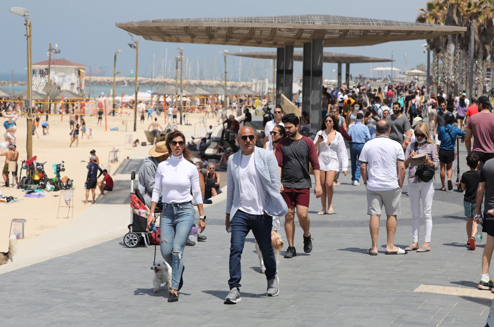 People without face masks enjoy a sunny day out at a beach in Tel Aviv, Israel, April 17, 2021. (EPA Photo)