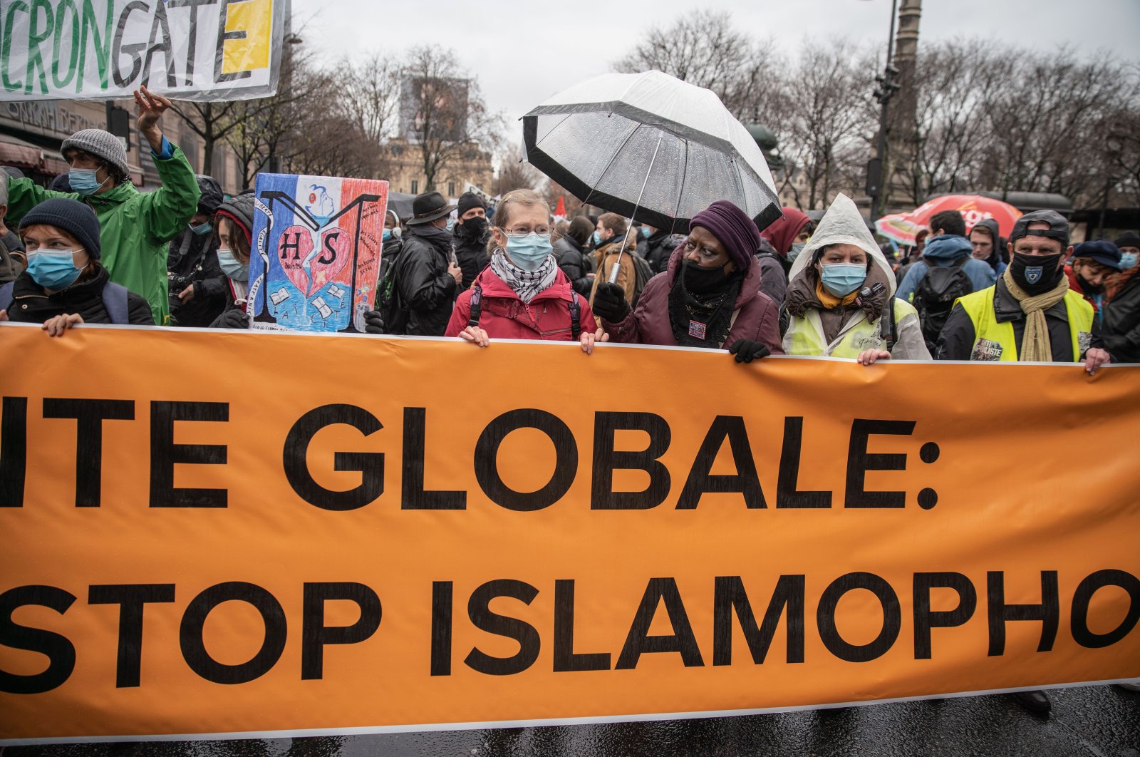 Protestors hold a banner at a demonstration against the draft global security bill and growing Islamophobia in Paris, France, Dec. 12, 2020. (Getty Images)