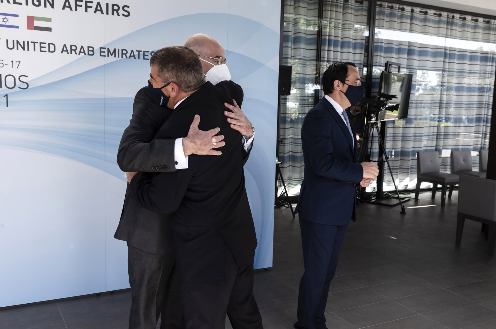 Greek Foreign Minister Nikos Dendias (L, back) hugs Israeli Foreign Minister Gabi Ashkenazi at a meeting in Paphos, Greece Cyprus, April 16, 2021. (EPA Photo)