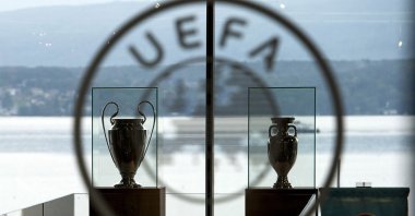 The UEFA Champions League trophy (L) and the Europa League trophy (R) on display at the UEFA headquarters in Nyon, Switzerland, Sept. 18, 2014. (EPA Photo)