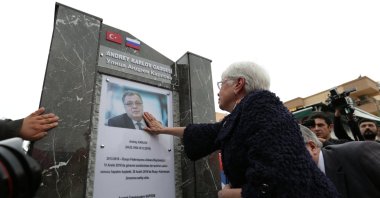 Marina Karlova, the widow of Andrei Karlov, touches a photo of the late envoy at a ceremony to name a street after him, in Antalya, southern Turkey, March 22, 2018. (REUTERS PHOTO)