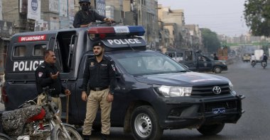 Police officers stand guard at a deserted road due to strikes called by the country's religious political parties over the security forces' crackdown against the banned Tehreek-e-Labaik Pakistan party, Karachi, Pakistan, Monday, April 19, 2021. (AP Photo)
