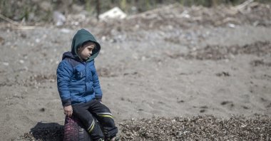 A migrant boy, who was pushed back from the Greece side, arrives at the Ayvalik district in Balikesir, Turkey, April 10, 2021. (EPA Photo)