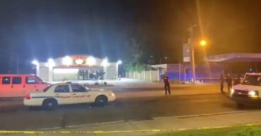 Police personnel and their vehicles are seen near the scene in the aftermath of a drive-by shooting at a liquor store in Shreveport, Louisiana, U.S., April 18, 2021. (Love Shreveport-Bossier via Reuters)