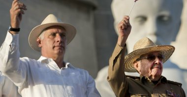 Cuba's President Miguel Diaz-Canel (L) and former Cuban President Raul Castro wave Cuban flags as they watch the annual May Day parade file past at Revolution Square in Havana, Cuba, May 1, 2019. (AP Photo)