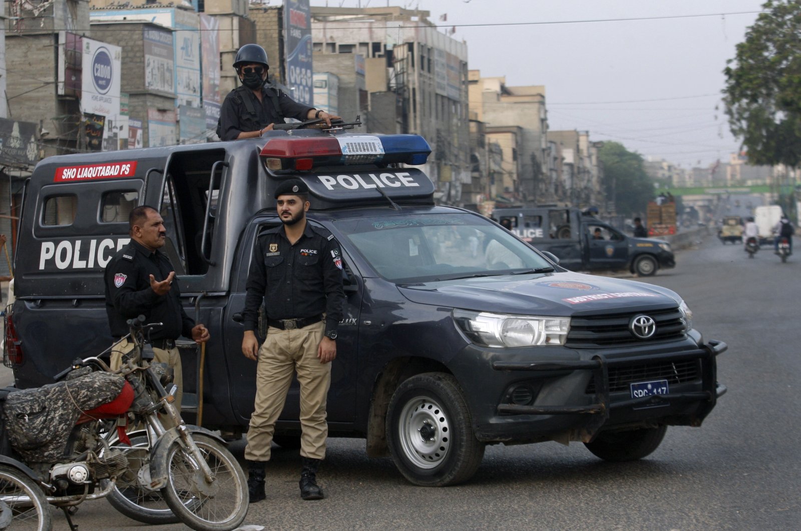 Police officers stand guard at a deserted road due to strikes called by the country's religious political parties over the security forces' crackdown against the banned Tehreek-e-Labaik Pakistan party, Karachi, Pakistan, Monday, April 19, 2021. (AP Photo)