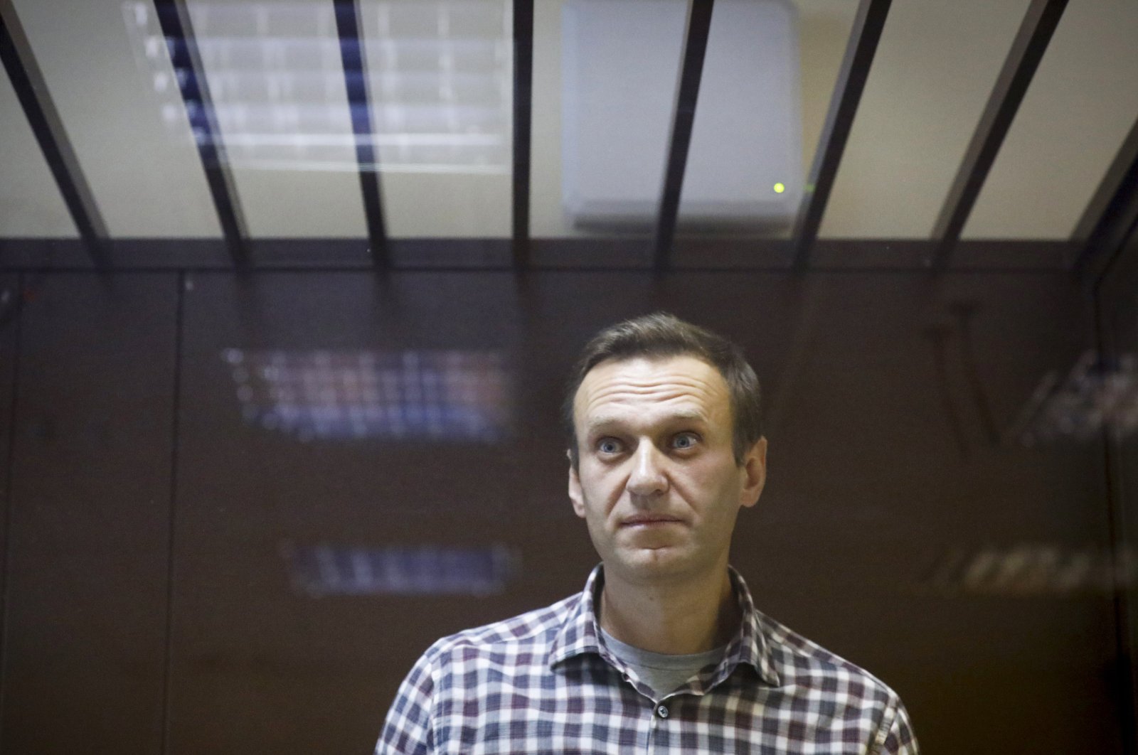 Russian opposition leader Alexei Navalny stands in a cage in the Babuskinsky District Court in Moscow, Russia, Feb. 20, 2021. (AP Photo/File)