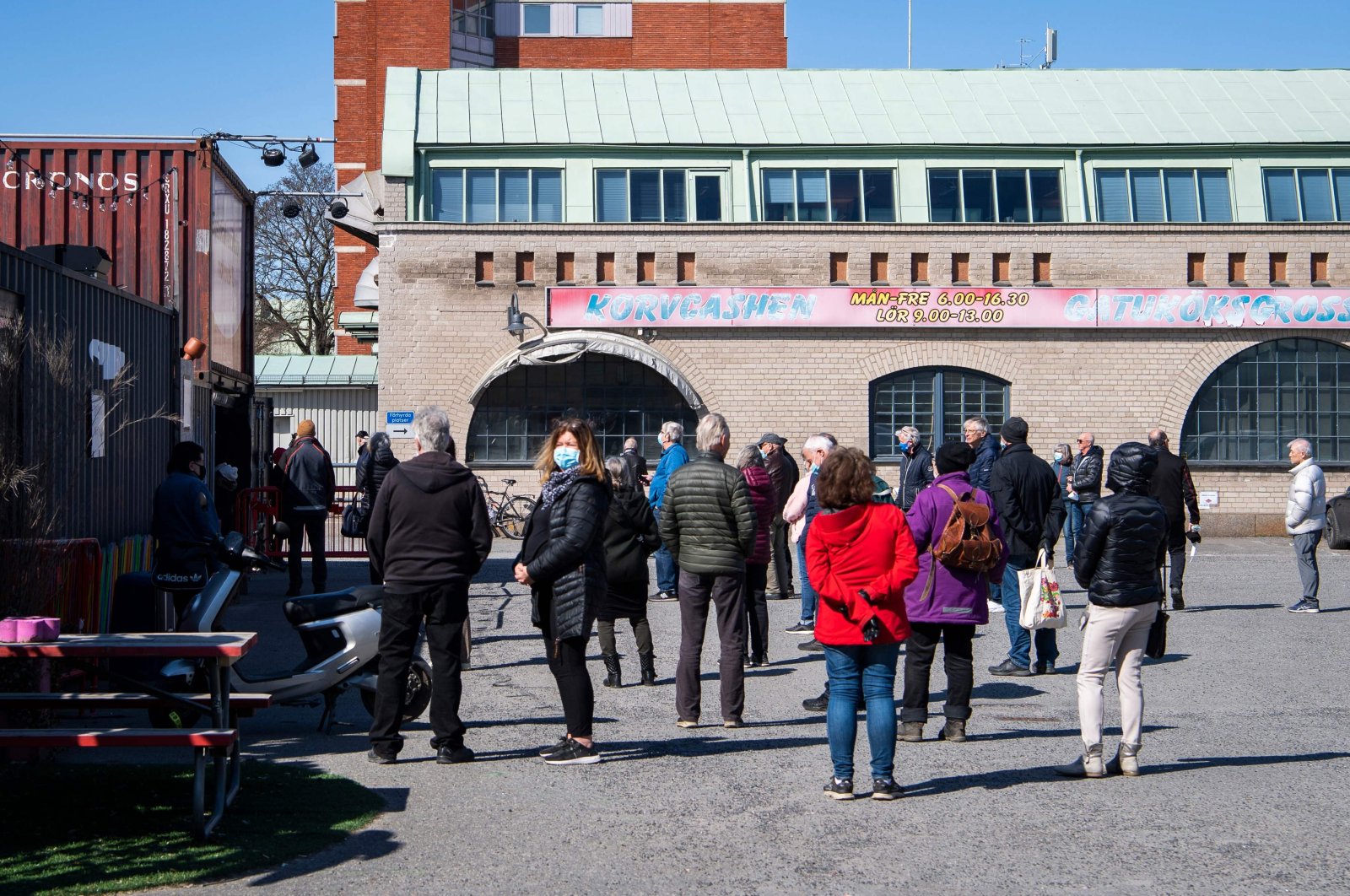 People wait in line to get their vaccines against Covid-19 outside a nightclub turned mass vaccination center in Stockholm, Sweden, on April 16, 2021, amid the  COVID-19 pandemic. (AFP) 