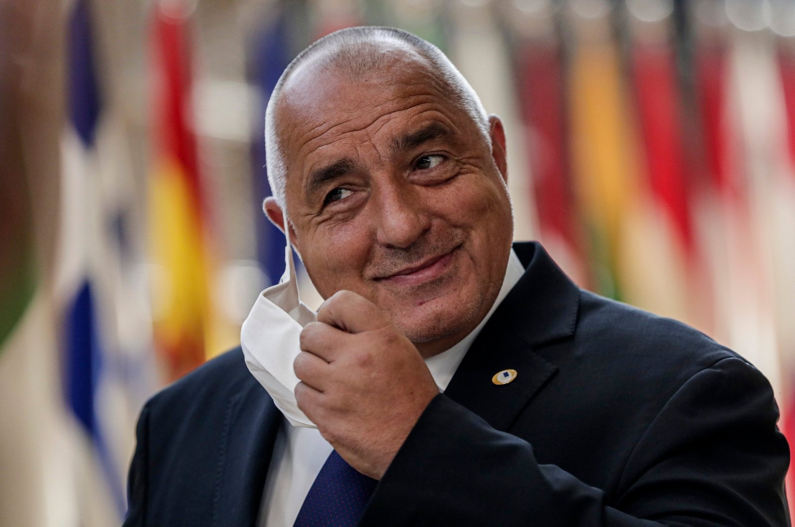 Bulgaria's Prime Minister Boyko Borissov takes off his protective face mask as he arrives for a European Union summit at the European Council building in Brussels, Belgium, July 18, 2020. (AP Photo)