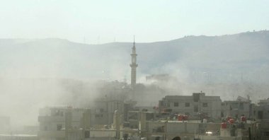 Smoke is seen above buildings following a toxic gas attack by pro-Assad regime forces in eastern Ghouta, on the outskirts of Damascus, Syria, Aug. 21, 2013. (AFP File Photo)