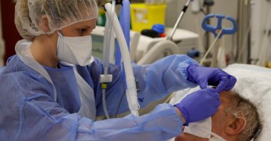A medical worker, wearing protective gear, works in the Intensive Care Unit (ICU) where patients suffering from the coronavirus disease are treated at Cambrai hospital, France, April 1, 2021. (Reuters Photo)