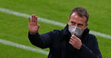 Bayern Munich's German head coach Hans-Dieter Flick waves as he arrives for an interview prior to the German first division Bundesliga football match in Munich, southern Germany, on April 20, 2021. (Photo by AFP)