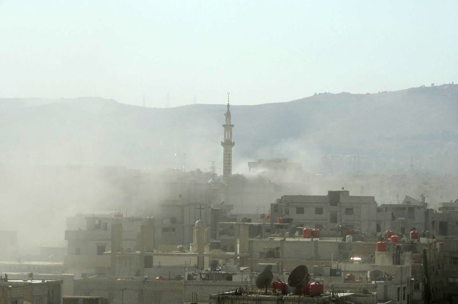 Smoke is seen above buildings following a toxic gas attack by pro-Assad regime forces in eastern Ghouta, on the outskirts of Damascus, Syria, Aug. 21, 2013. (AFP File Photo)