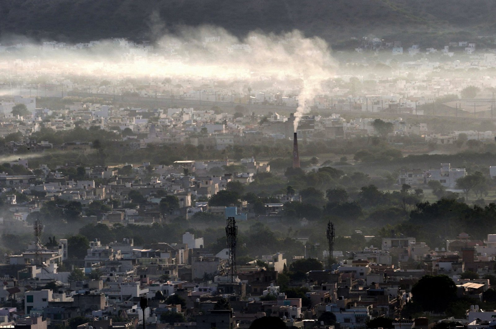 Smoke billows from a factory chimney during a smoggy morning in Ajmer, northern India on November 2, 2020. (AFP Photo)