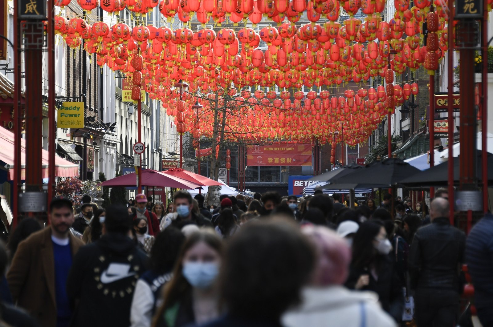 People walk and queue outside restaurants in Chinatown, in London, U.K., April 17, 2021. (AP Photo)


