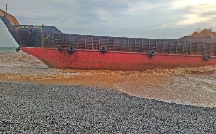 This photo provided by the Philippine Coast Guard shows the cargo vessel LCT Cebu Great Ocean aground along the shoreline of Barangay Cantapoy, Malimono, Surigao del Norte, southern Philippines, April 19, 2021. (AP Photo)