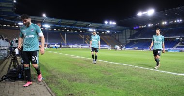 Schalke 04's Sead Kolasinac (L) and teammates leave the pitch after being relegated from the Bundesliga following a defeat against Arminia Bielefed on Tuesday, April 20, 2021. (Wolfgang Rattay/DFL/Pool via Reuters)