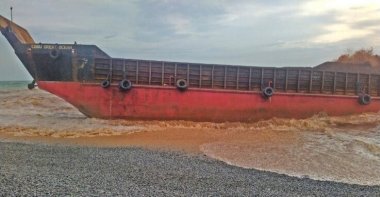 This photo provided by the Philippine Coast Guard shows the cargo vessel LCT Cebu Great Ocean aground along the shoreline of Barangay Cantapoy, Malimono, Surigao del Norte, southern Philippines, April 19, 2021. (AP Photo)