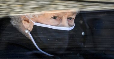 Britain's Queen Elizabeth II follows the coffin in a car as it makes it's way past the Round Tower during the funeral of Britain's Prince Philip inside Windsor Castle in Windsor, England, April 17, 2021. (AP Photo)