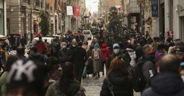 People walk in Istiklal Avenue, the main shopping street of Istanbul, Turkey, March 25, 2021. (AP Photo)