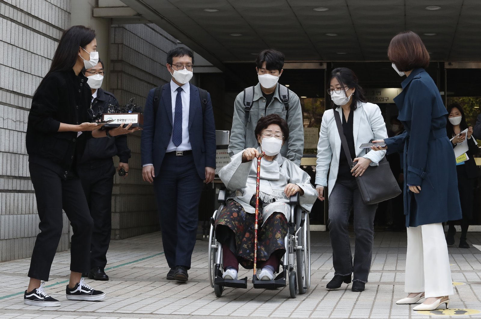 Former South Korean comfort woman Lee Yong-soo in a wheelchair leaves the Seoul Central District Court in Seoul, South Korea, Wednesday, April 21, 2021. (AP Photo)