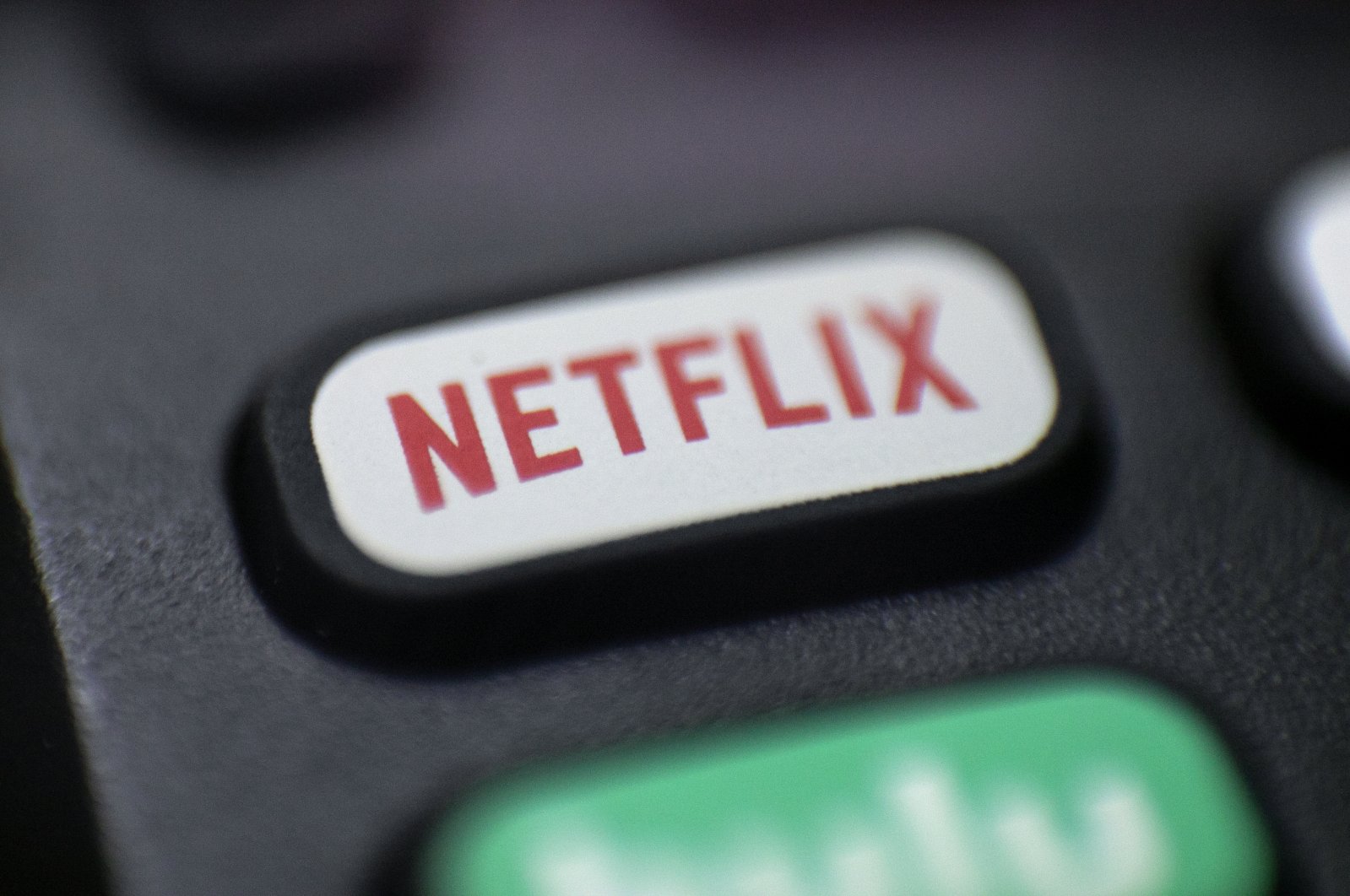 A Netflix logo is seen on a remote control in Portland, Oregon, Aug. 13, 2020. (AP Photo)