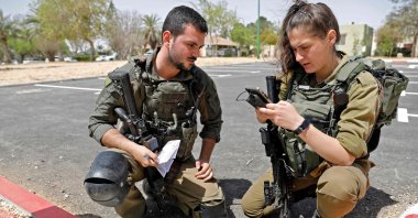 Israeli soldiers inspect a piece of debris after a missile launched from Syria landed in the vicinity of the Dimona nuclear site in Israel's southern Negev desert, Israel, April 22, 2021. (AFP Photo)