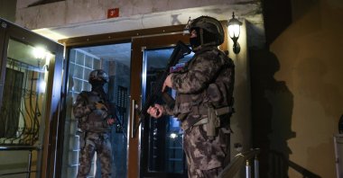 Special operations police stand guard outside a home being raided, in Istanbul, Turkey, Dec. 18, 2020. (AA Photo)