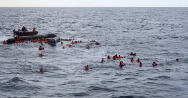 Refugees and migrants are rescued by members of the Spanish NGO Proactiva Open Arms, after leaving Libya trying to reach European soil aboard an overcrowded rubber boat in the Mediterranean sea, Nov. 11, 2020. (AP File Photo)