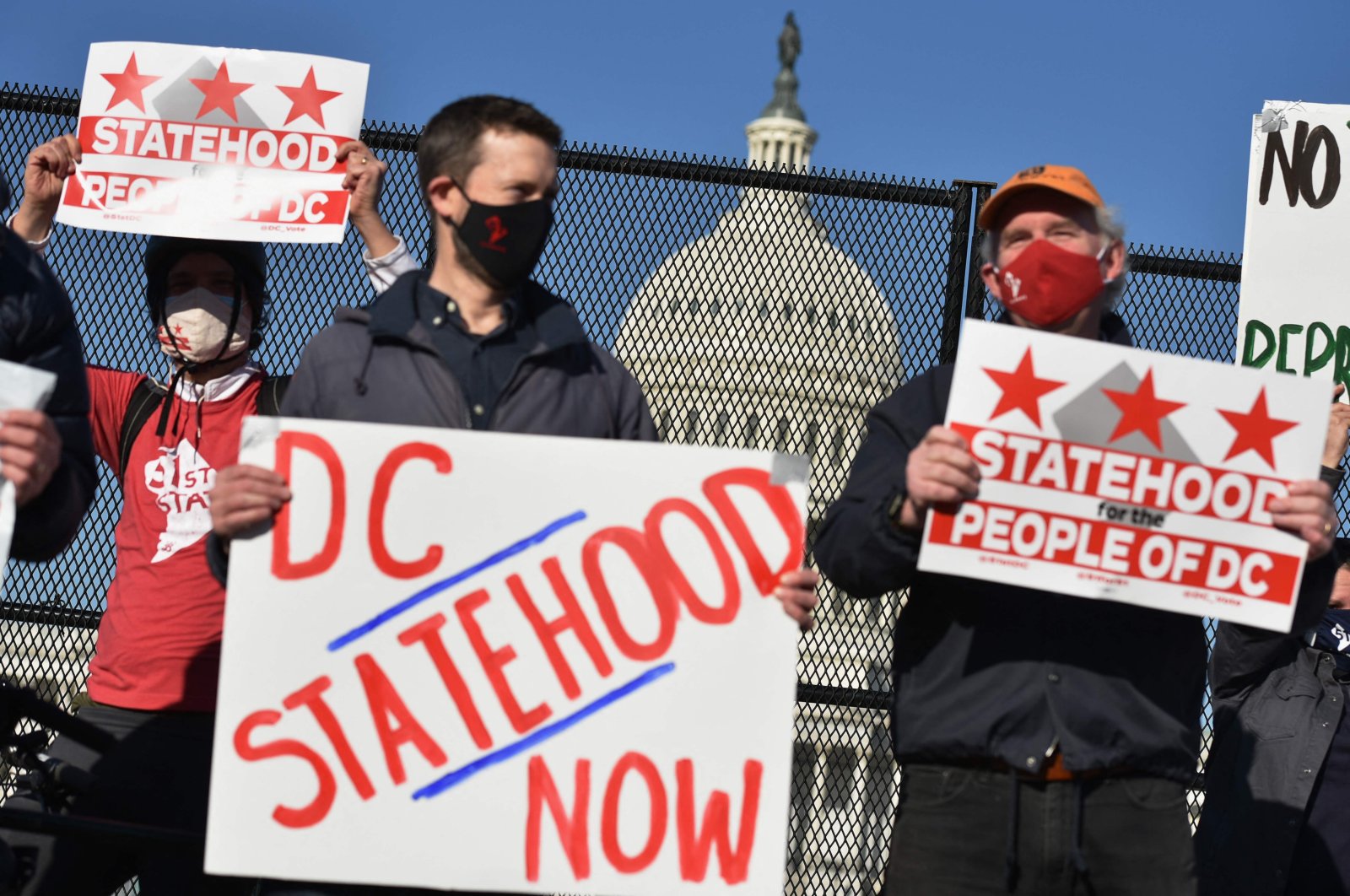 In this file photo activists hold signs as they take part in a rally in support of D.C. statehood near the U.S. Capitol in Washington, D.C., March 22, 2021. (AFP Photo)
