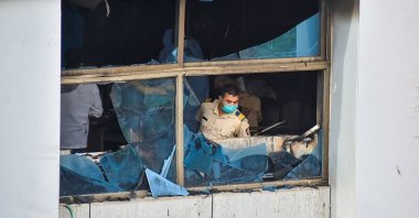 A policeman inspects a burnt-out room at the Vijay Vallabh Hospital in Virar, on the outskirts of Mumbai, India, April 23, 2021. (AFP Photo)