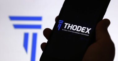 The Thodex cryptocurrency exchange logo is displayed on a mobile phone screen, April 22, 2021. (AA Photo)