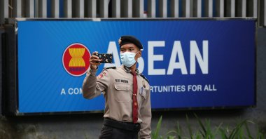 A police officer takes a picture outside the Association of Southeast Asian Nations (ASEAN) secretariat building, ahead of the ASEAN leaders' meeting in Jakarta, Indonesia, April 23, 2021. (Reuters Photo)