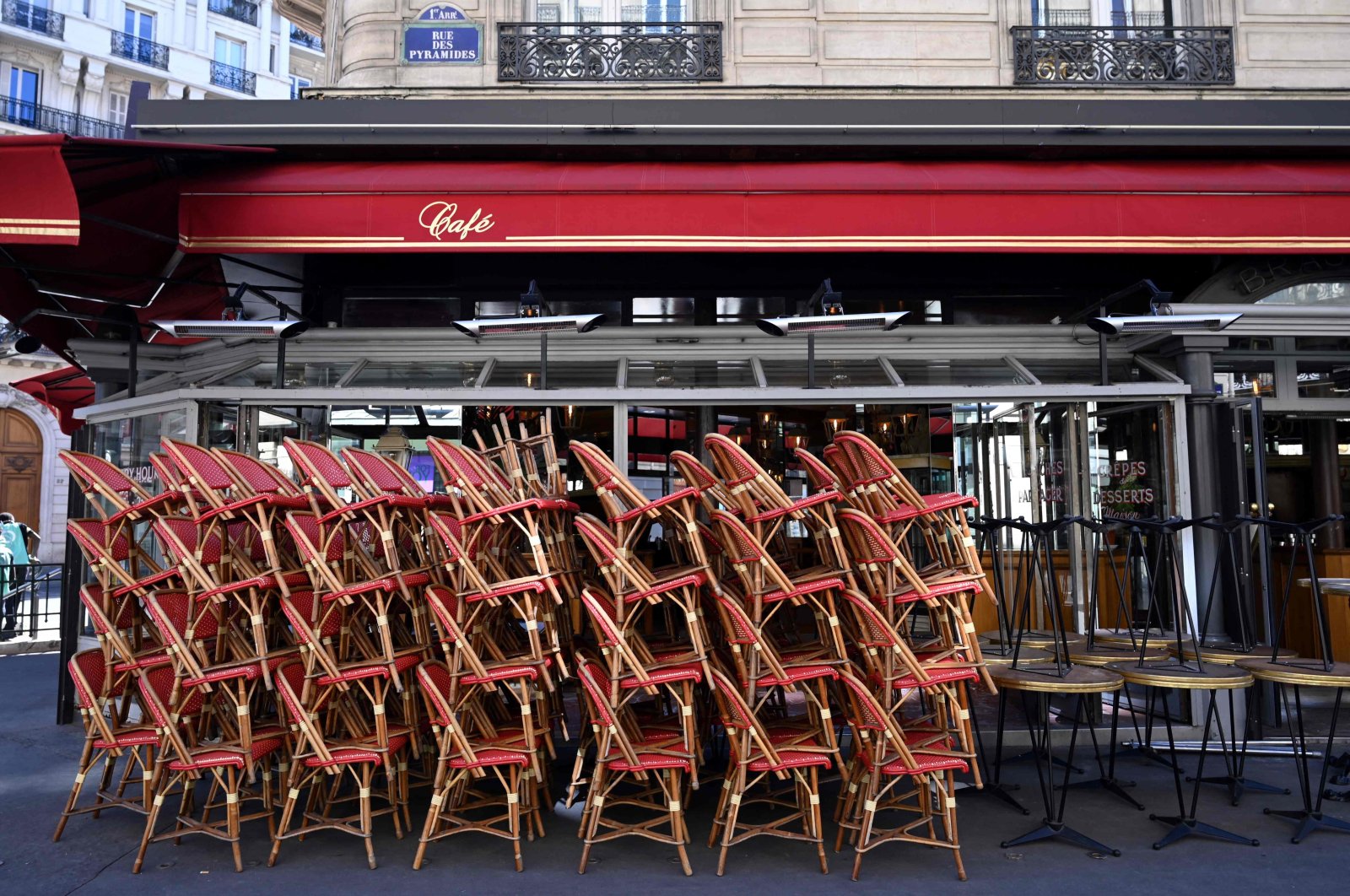 Chairs are piled on a terrace of a closed restaurant as the government eases lockdown measures taken to curb the spread of the COVID-19 pandemic, Paris, France, March 15, 2021. (AFP Photo)