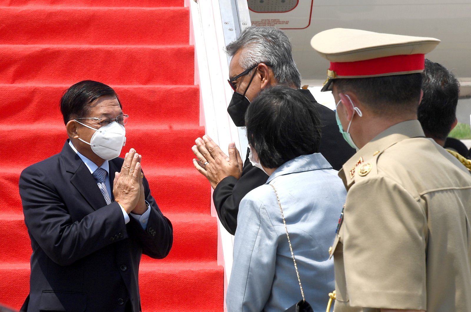 Myanmar's junta chief Senior General Min Aung Hlaing (L) gestures as he is welcomed upon his arrival ahead of the ASEAN leaders' summit, at the Soekarno Hatta International airport in Tangerang, on the outskirts of Jakarta, Indonesia, April 24, 2021. (Indonesian Presidential Palace via Reuters)