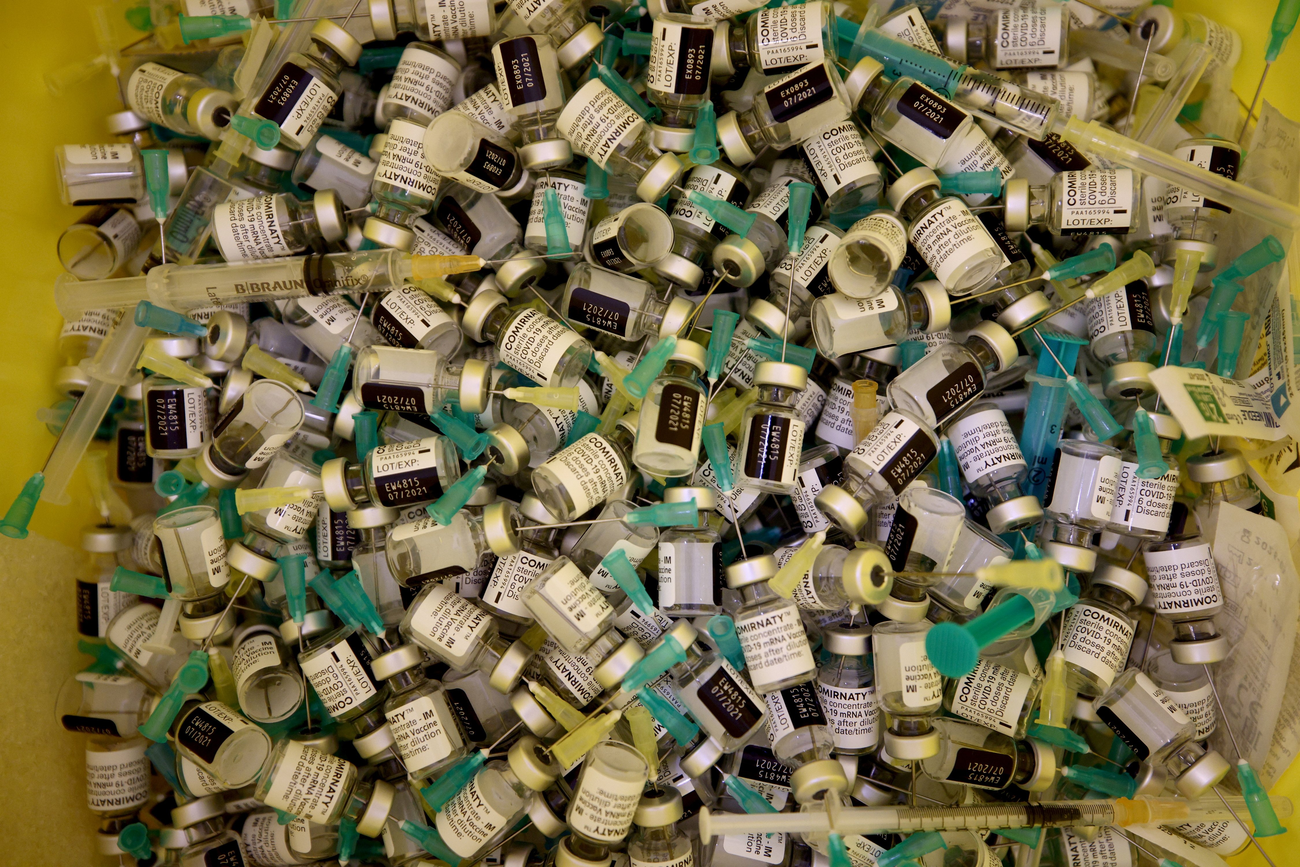 Empty Pfizer-BioNTech COVID-19 vaccine vials and syringes collect in a disposal container at Austria Center, which has been set up as a coronavirus mass vaccination center, Vienna, Austria, April 22, 2021. (Rueters Photo)