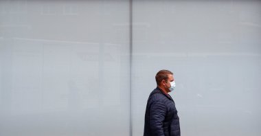 A person walks past a Caixabank's bank branch in Madrid, Spain, April 20, 2021. (Reuters Photo)