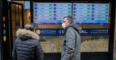 Two men stand in front of a Bitcoin shop in Istanbul, Turkey, Jan. 19, 2021. (Shutterstock Photo)