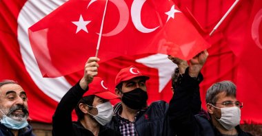 Turkish counter-protestors are kept apart from Armenian protestors to avoid confrontation in front of the Turkish Embassy on the 106th anniversary of the 1915 events in Washington, DC on April 24, 2021. (AFP)