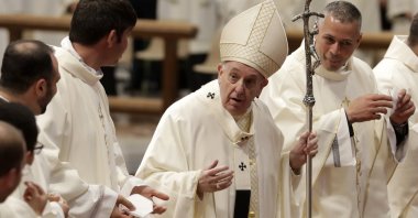 Pope Francis tells newly ordained priests to remove their face masks, used to curb the spread of COVID-19, for a group photo at the end of their ordination ceremony, inside Saint Peter's Basilica, at the Vatican, April 25, 2021. (AP Photo)