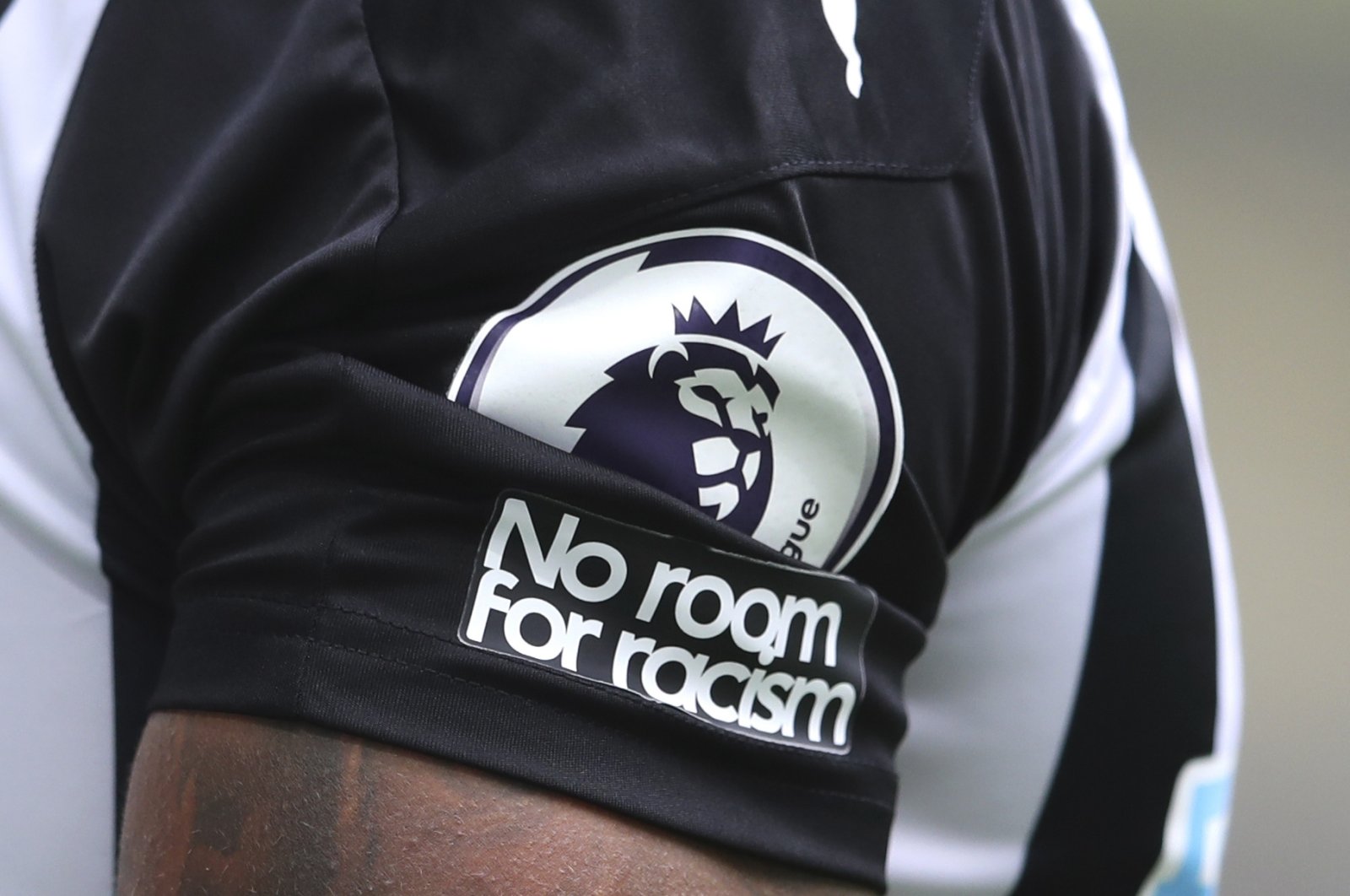 The "No room for racism" badge is seen on the shirt of a Newcastle United players, Newcastle, England, Sept. 20, 2020.