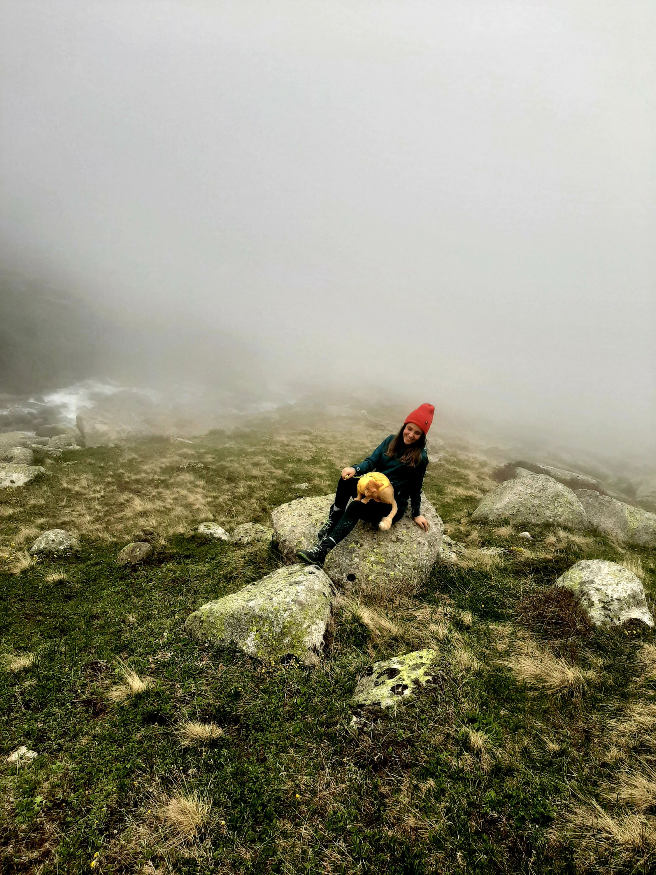 Özge Kübra Teymur sits on a rock on a mountain with her cat Azman sitting on her lap, Rize, Turkey, April 20, 2021. (DHA Photo)