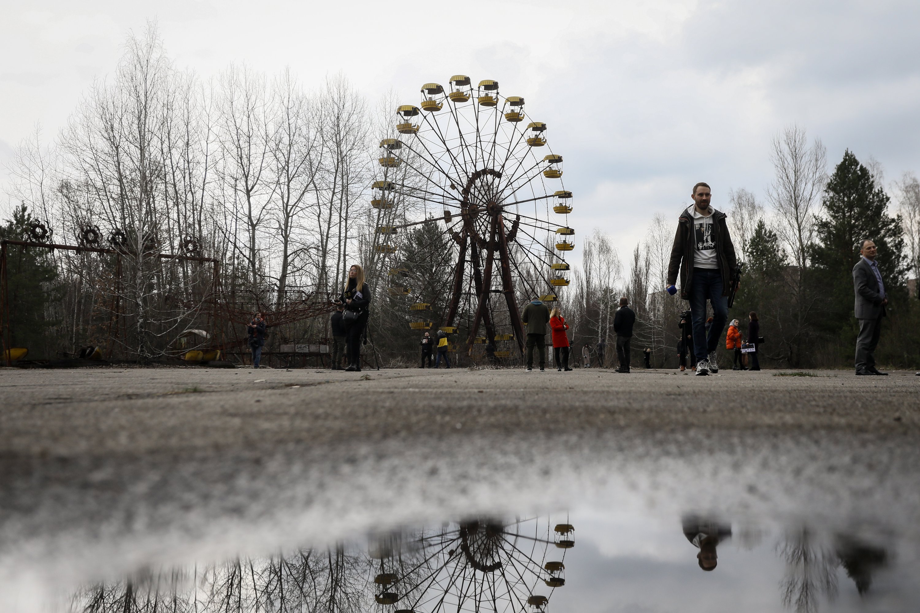 People walk near the Ferris wheel in the abandoned city of Pripyat, near Chernobyl, Ukraine, April 15, 2021. (EPA Photo)