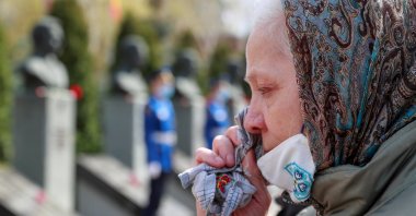 A woman sheds a tear during a commemoration ceremony marking the 35th anniversary of the Chernobyl disaster at a memorial to firefighters and workers, who died following the explosion of a reactor at the Chernobyl Nuclear Power Plant, in Kyiv, Ukraine, April 26, 2021. (Reuters Photo)