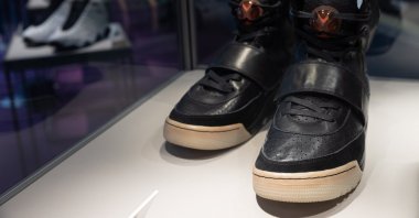 Kanye West 'Grammy Worn' Nike Air Yeezy 1 Prototype sneakers (R) are on display during a Sotheby's auction preview in Hong Kong, China, 17 April 2021. (EPA Photo) 