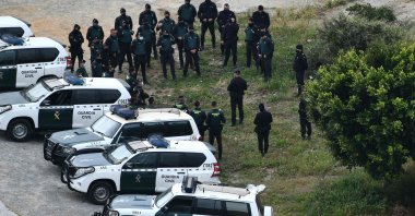 Spanish Guardia Civil members stand guard in the Spanish exclave of Ceuta bordering Morocco, after an attempt by migrants to breach the border fence, April 13, 2021. (AFP)
