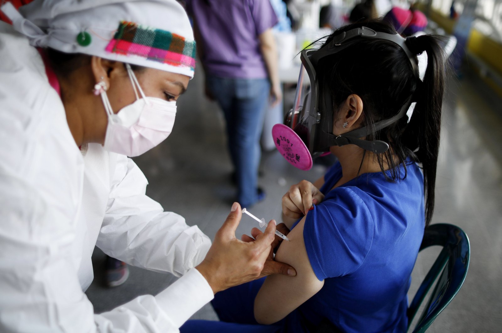 A health care worker inoculates a woman with Sputnik V vaccine, in Tegucigalpa, Honduras, Apr. 23, 2021. (AP PHOTO) 