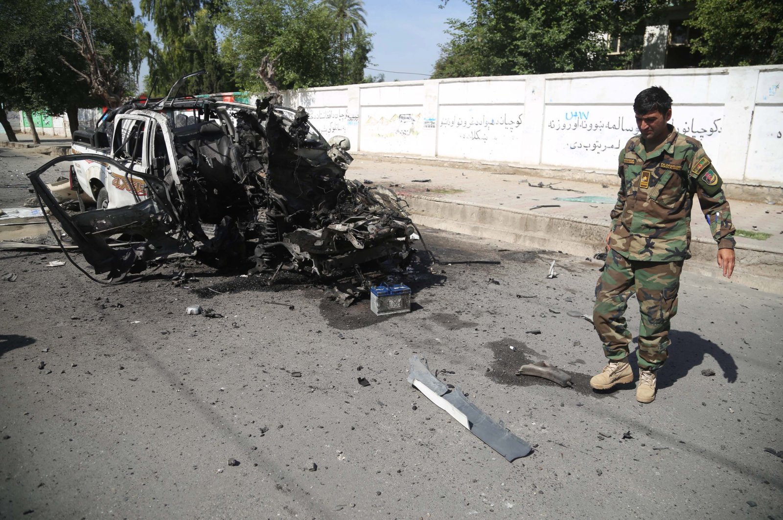 Afghan security officials inspect the scene of a bomb blast that targeted a vehicle of the Afghan National Army, in Jalalabad, Afghanistan, April, 26, 2021. (EPA Photo)